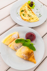 An Omelet with lettuce and and sweet pancakes