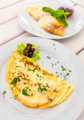 An Omelet with lettuce and and sweet pancakes