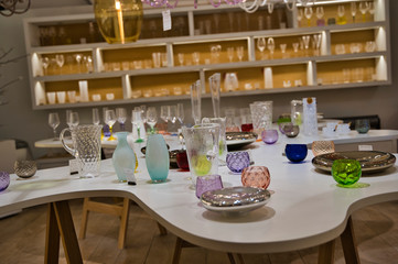 shelving shelves with different vintage beautiful dishes, plates, vases,