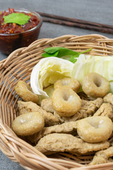 Meatballs with spicy sauce in basket on table.