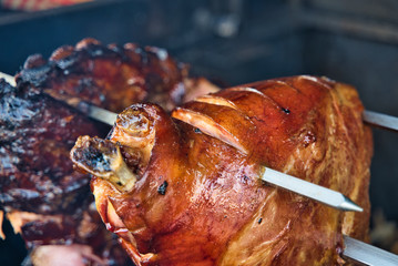 Close up of Roasted shoulder of pork on the grill.