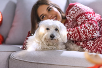 Beautiful woman with her dog enjoying Christmas eve/New Year.