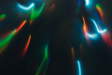 Blur party lights. Smeared multicolor neon illuminated lines. Dark abstract background.