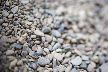 River or sea stone background. Set of all kinds of stones. Part of image is blurred.