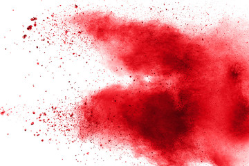 abstract red dust splattered on white background. Red powder explosion.Freeze motion of red particles splashing.