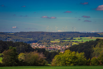The village of Steinheim am Albuch in Baden-Württemberg, Germany. Small german town from above. Blue sky, wind turbines in the background. Tourism, travel concept.