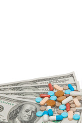 colored medicinal pills and american dollars on white a background