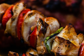Juicy steaming meat on a charcoal grill, pork steaks, chicken breast, sausages, pieces of meat chops at a street food festival