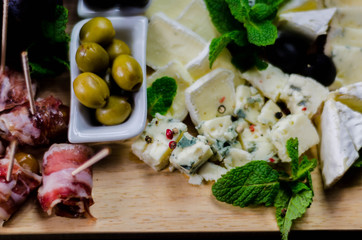 set of different cheeses on a wooden board, cheese board, delicious snack, healthy and exclusive food