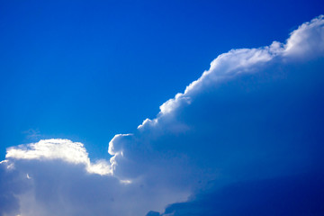 Sunlight rays from the clouds on a blue sky