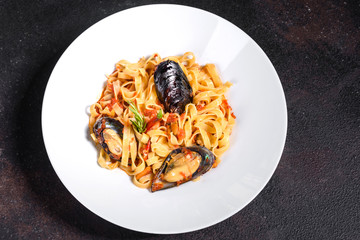 Homemade pasta with mussels, sprinkle with chopped parsley and basil. Delicious of pasta with mussel