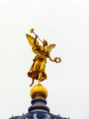 Golden statue of Muse on top of Academy of Arts in Dresden, Germany