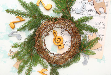 Composition with note sheets and Christmas decor on light background