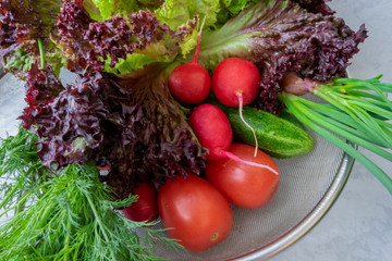 Photo of a wire shopping basket full of fresh fruit and vegetables