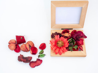 Potpourri or dried petals flowers colorful set in wooden casket, The conceptual displayed with twin photo wooden frame on white background. Isolated top view.
