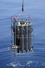 CTD rosette sampler with bathometers and other science equipment for measurement of underwater environment parameters like temperature, salinity and others.