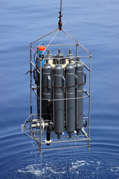 CTD rosette sampler with bathometers and other science equipment for measurement of underwater environment parameters like temperature, salinity and others.
