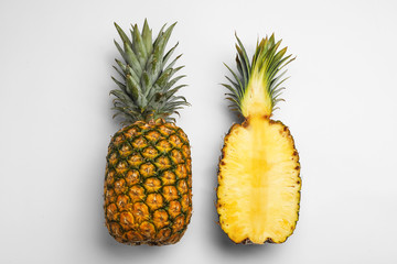 Tasty raw cut pineapples on white background, top view