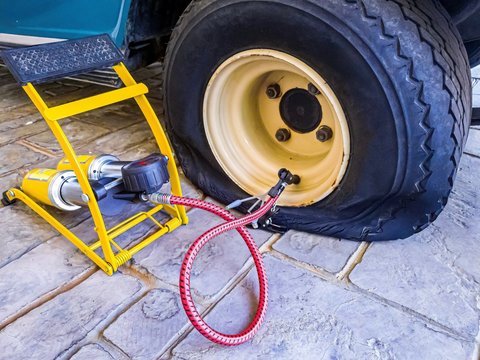 Flat tire and air pumper tool fixing and refill air to old tire of golf cart.
