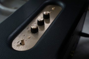 Close-up detail of sound volume controls in vintage style.