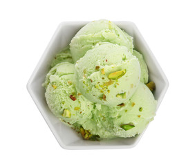 Bowl of delicious pistachio ice cream on white background, top view