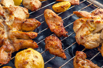 Roasted Potatoes and Chicken Slices on Stainless Steel Cooking Grid. Grilled Chicken Breast with Slices Made for Marinade to Penetrate the Meat Better, and Ensure Chicken Cooked Evenly.