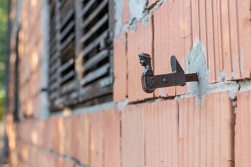 Forged stupor holder for window shutters in the form of a female