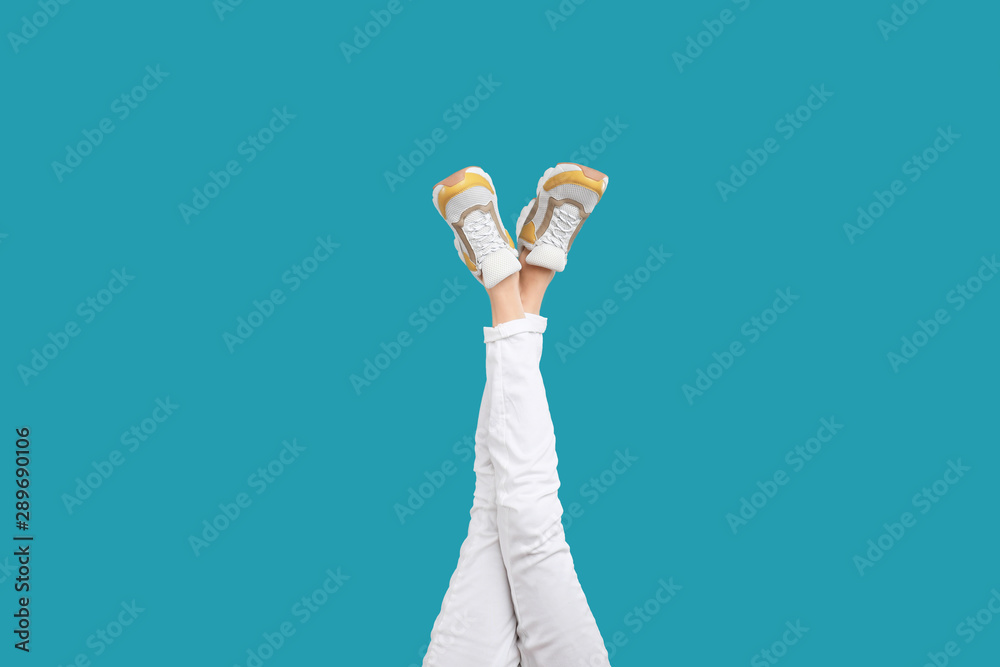 Canvas Prints Woman in stylish sport shoes on light blue background