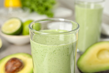 Glass of tasty avocado smoothie on table, closeup
