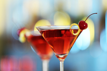 Glass of fresh alcoholic cocktail against blurred background