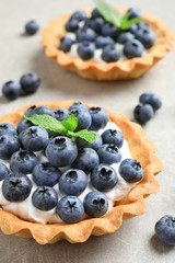 Delicious sweet pastry with berries on grey table, closeup. Space for text