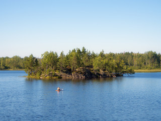 Fototapeta na wymiar man floats on the lake