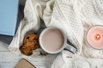 Flat lay composition with cup of hot cocoa on white wooden table. Winter drink