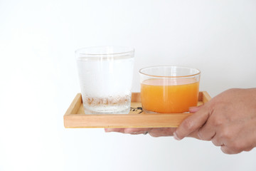 The water and orange juice are placed in a wooden tray, suitable for drinking to refresh and heal the body.