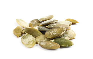 Pile of raw pumpkin seeds on white background