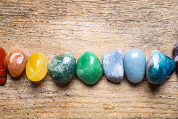 Flat lay composition with different gemstones on wooden table