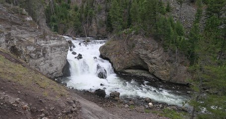 Yellowstone National Park river waterfall mountain. National Park in Wyoming. Geothermal ecosystem environment. Biology geography and ecology. Millions of tourist and visitors each year.