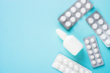 Pills on blue background top view.