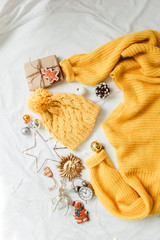 sweater, knitted mittens and Christmas decorations and gift on white background. Holiday and christmas concept.  Flat lay Top view