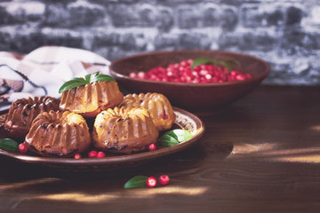 homemade cake. cupcakes with berries in a plate on the table. muffins with berries of a cowberry close up.