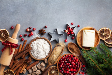 christmas cookies and spices on wooden background