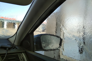 washing car in a self-service car wash station. Shooting from inside the car