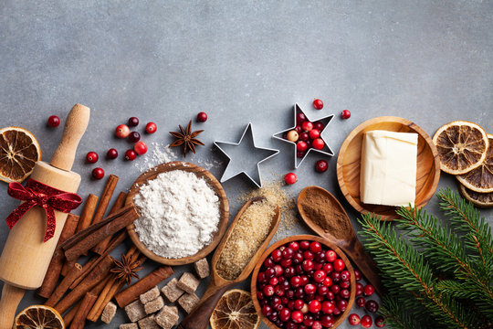christmas cookies and spices on wooden background