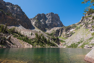 Rocky Mountain National Park landscape of Emerald Lake agaist mountain tops on a sunny summer day
