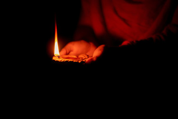 Woman Holding Diwali Diya or Lamp.  Diwali or deepavali photo with female holding oil lamp or diya...