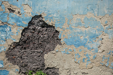 Old plaster is crumbling from the wall. urban background grunge wall texture