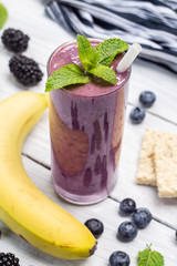 Banana, blueberry, blackberry, oatmeal and yogurt smoothies in a glass