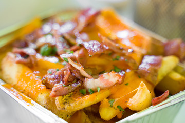 Fast food. French fries with bacon.