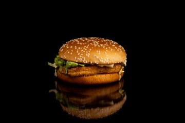 Burger with sesame seeds, chicken and sauce