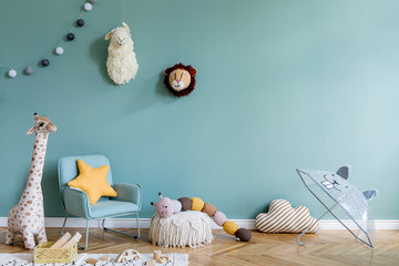 Stylish scandinavian kid room with toys, teddy bear, plush animal toys, mint armchair, umbrella, cotton balls. Modern interior with eucalyptus background walls, Design interior of childroom. Template 